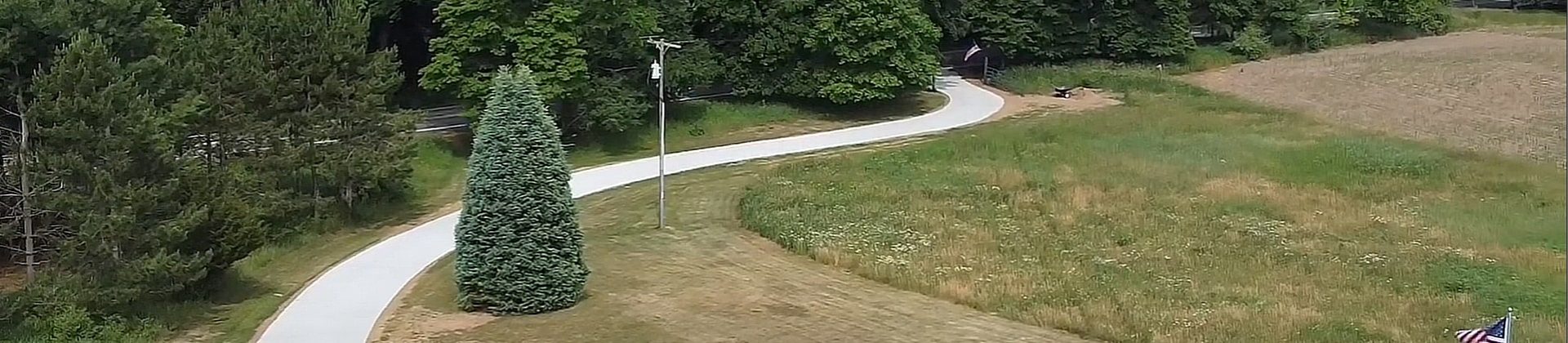 A long, winding concrete driveway.