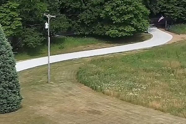 A long, winding concrete driveway.