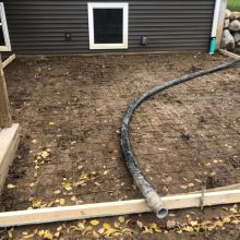 An exposed aggregate patio under construction.