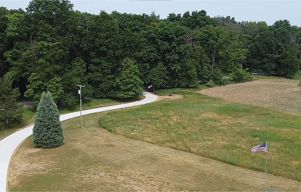 A long winding concrete driveway.