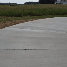 A long winding concrete driveway.