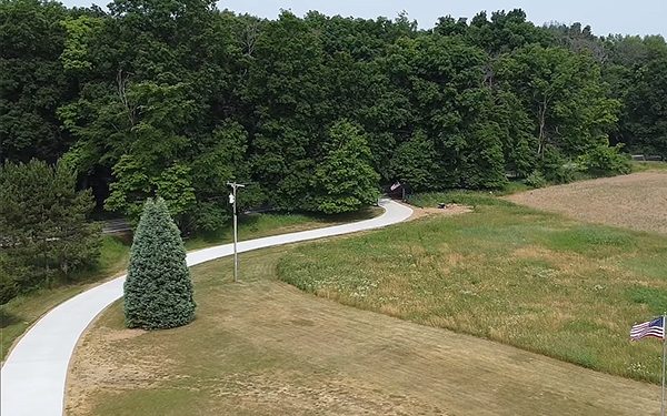 A long winding concrete driveway.