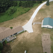 A long winding concrete driveway.