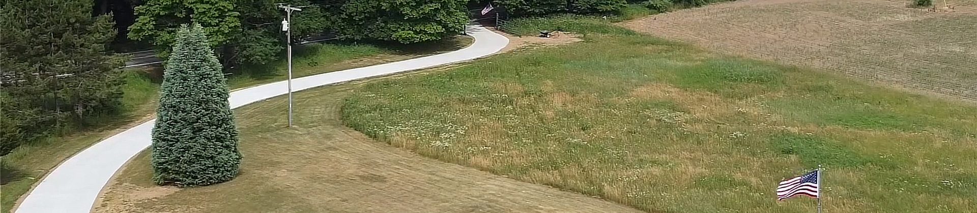 A long winding concrete driveway.