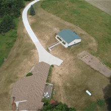 A long winding concrete driveway.