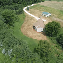 A long winding concrete driveway.