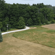 A long winding concrete driveway.