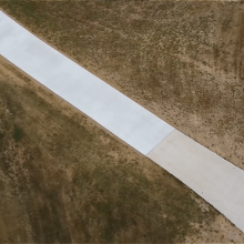 A long winding concrete driveway.