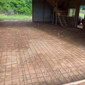 A pole barn floor that is under construction.