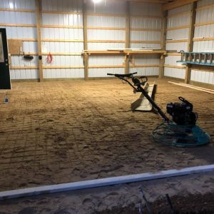 A pole barn floor that is under construction.