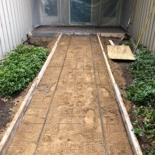 A decorative concrete walkway under construction.