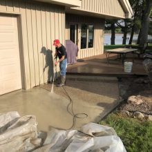 An exposed aggregate concrete walkway under construction.